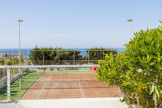 Shared tennis court for guests at Ikaria Village, Paphos.