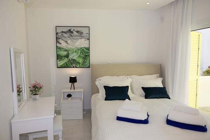 Master bedroom with double bed at Yellow16 Holiday Apartment.